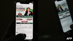 A man checks a social app to monitor the official site of the Pakistan Tehreek-e-Insaf party (PTI) party, as a telethon to launch the PTI manifesto and raise campaign funds is launched, amid widespread Internet disruptions, in Islamabad, Jan. 7, 2024.