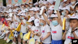 FILE - Children cheer during the 73rd anniversary of the International Children's Day at the Taesongsan Amusement Park in Pyongyang, North Korea on June 1, 2023. 