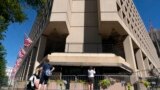 FILE - People take photos of the FBI building headquarters in Washington, Aug. 13, 2022.