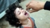 FILE - A health worker administers polio vaccine to a child in a neighborhood of Lahore, Pakistan, Nov. 27, 2023. Pakistan and Afghanistan are the last two countries where the virus continues to paralyze children. 