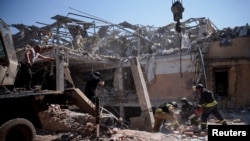 Ukrainian emergency personnel work among the rubble of a destroyed hotel following a Russian strike, amid the Russian invasion of Ukraine, in the town of Kramatorsk, Ukraine, Aug. 25, 2024. 