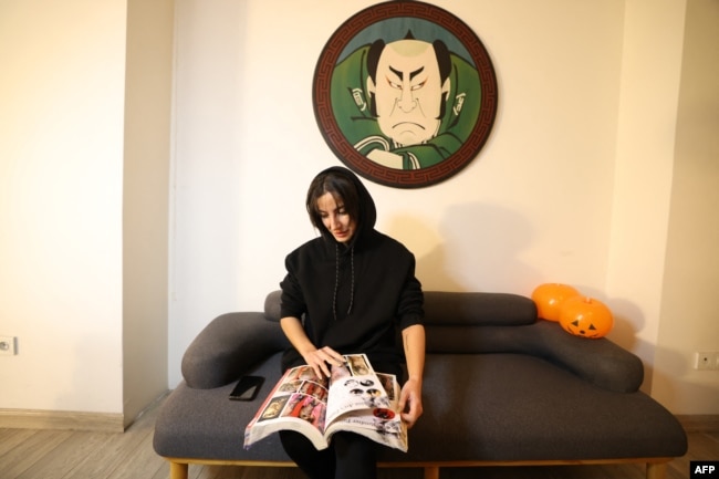 A customer looks through designs at a tattoo studio in Tehran, Iran, on Nov. 7 2023.