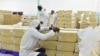 FILE - A man tags bags of processed nuts in a factory in the central Ivorian city of Bouake, May 24, 2018. Demand for processed foods is rising in Africa, but a new report says a variety of barriers are hindering progress.