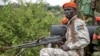 A South Sudanese military police officer sits on a truck while monitoring the area as troops belonging to the South Sudanese Unified Forces take part in a deployment ceremony at the Luri Military Training Centre in Juba, Nov. 15, 2023. 
