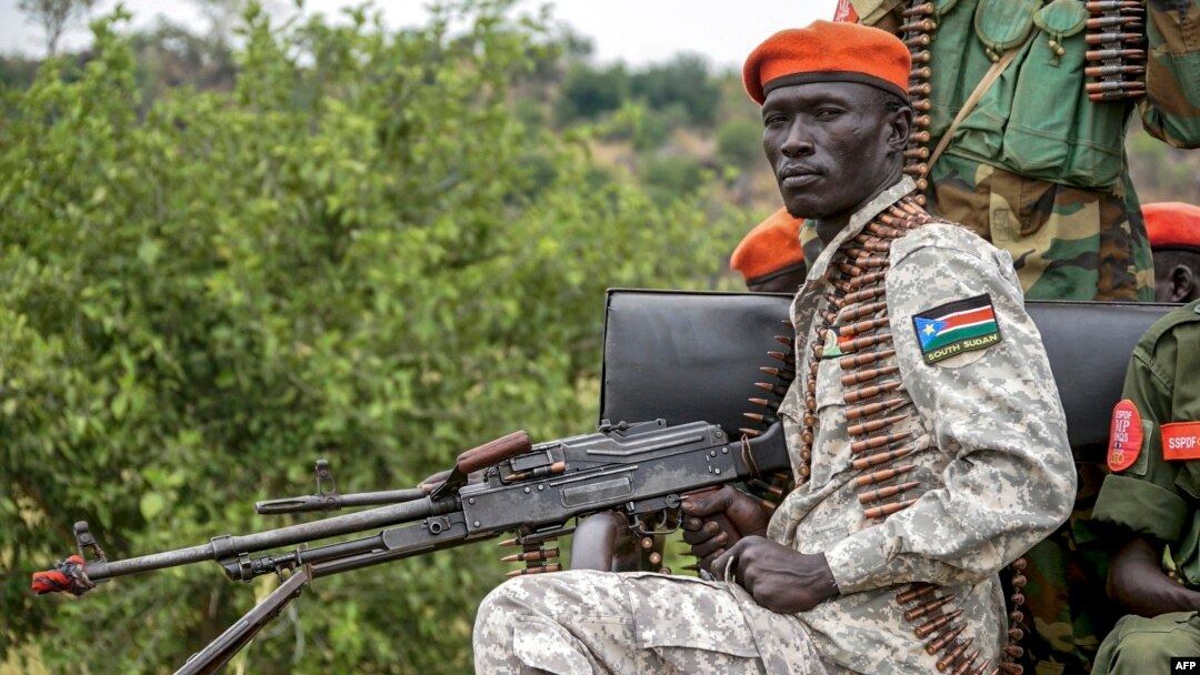 A South Sudanese military police officer sits on a truck while monitoring the area as troops belonging to the South Sudanese Unified Forces take part in a deployment ceremony at the Luri Military Training Centre in Juba, Nov. 15, 2023. 