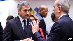 Paraguay's President Mario Abdo Benitez, left, talks to Dominican Republic's President Luis Abinader Corona at the roundtable during the third EU-CELAC summit, in Brussels, July 18, 2023.