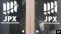 A security guard stand at a door of Tokyo Stock Exchange, Nov. 9, 2023, in Tokyo. 
