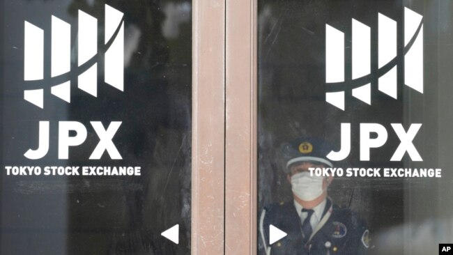 A security guard stand at a door of Tokyo Stock Exchange, Nov. 9, 2023, in Tokyo.