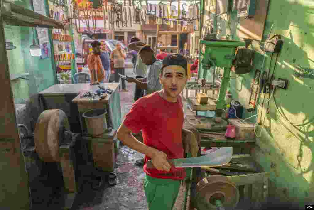 Menno, in his family’s knife-sharpening shop, says, “I expected high profits this Eid and planned my marriage accordingly. But I’ve delayed it for a couple more months, since I can’t commit to all the financial obligations.” (Hamada Elrasam/VOA)