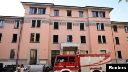 Firefighters work at the scene following a fire in a retirement home in Milan, Italy, July 7, 2023.