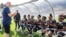 FILE - FIFA president Gianni Infantino talks to players from the Musanze women's amputee football team before launching the women's Amputee Football championship in Rwanda at the Pele Stadium in Kigali, Rwanda, March 16, 2023.