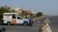 A guard stands on a barricaded road that leads to the beach, after a ban was imposed on coastal activities following the cyclonic storm, Biparjoy, over the Arabian Sea, at Clifton Beach in Karachi, Pakistan, June 12, 2023. 