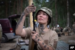 A volunteer for an air-defense unit receives combat training in the Bucha region, near Kyiv, Ukraine, Aug. 3, 2024.