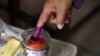 A person dips their finger in ink at a Phnom Penh, Cambodia, polling station during Cambodia's general election, July 23, 2023. A recent report by Freedom House highlighted Cambodia as one of the places that experienced attempts to control, hinder or interfere with elections. 