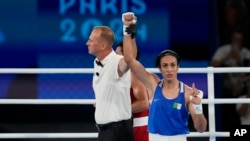 Algeria's Imane Khelif gestures after defeating Thailand's Janjaem Suwannapheng in their women's 66 kg semifinal boxing match at the 2024 Summer Olympics, Aug. 6, 2024, in Paris.