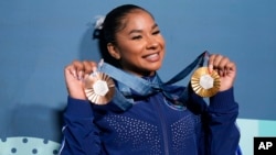 FILE - Jordan Chiles, of the United States, holds up her medals after the women's artistic gymnastics individual apparatus finals Bercy Arena at the 2024 Summer Olympics, in Paris, France, Aug. 5, 2024.