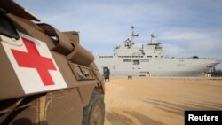 A military medical vehicle stands near the French ship amphibious helicopter carrier Dixmude, amid the ongoing conflict between Israel and the Palestinian Islamist group Hamas, in the city of Al-Arish, Sinai peninsula, Egypt, Jan. 21, 2024. 