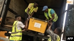 National Elections Commission agents load trucks with election material in Monrovia, on Oct. 9, 2023. 