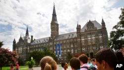 FILE - Prospective students tour Georgetown University' on July 10, 2013, in Washington. 