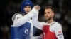 Palestinian Omar Yaser Ismail, left, competes with Refugees Olympic Team's Hadi Tiranvalipour in a men's 58kg Taekwondo match during the 2024 Summer Olympics, at the Grand Palais, in Paris, France, Aug. 7, 2024.