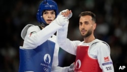 Palestinian Omar Yaser Ismail, left, competes with Refugees Olympic Team's Hadi Tiranvalipour in a men's 58kg Taekwondo match during the 2024 Summer Olympics, at the Grand Palais, in Paris, France, Aug. 7, 2024.