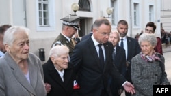 Poland's President Andrzej Duda and survivors of the Nazi bombing of Wielun attend a wreath-laying ceremony at the monument in memory of victims of the Nazi bombing, following the ceremony in Wielun, Sept. 1, 2024.