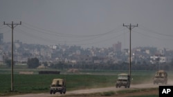 Israeli soldiers move near the Israeli-Gaza border as seen from southern Israel, Jan. 8, 2024.