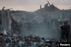 Tim penyelamat bekerja di lokasi serangan militer Rusia, di tengah serangan Rusia ke Ukraina, di Desa Hroza, di wilayah Kharkiv, Ukraina, 5 Oktober 2023. (Foto: REUTERS/Vyacheslav Madiyevskyy)