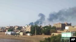 FILE - Smoke rises over Khartoum, June 23, 2023, as clashes continued between warring factions in and around Sudan's capital.
