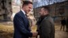 In this photo provided by the Ukrainian Presidential Press Office, President Volodymyr Zelenskyy, right, and Netherlands Prime Minister Mark Rutte talk near apartment houses damaged in Russian missile attacks in Kharkiv, Ukraine, March 1, 2024.