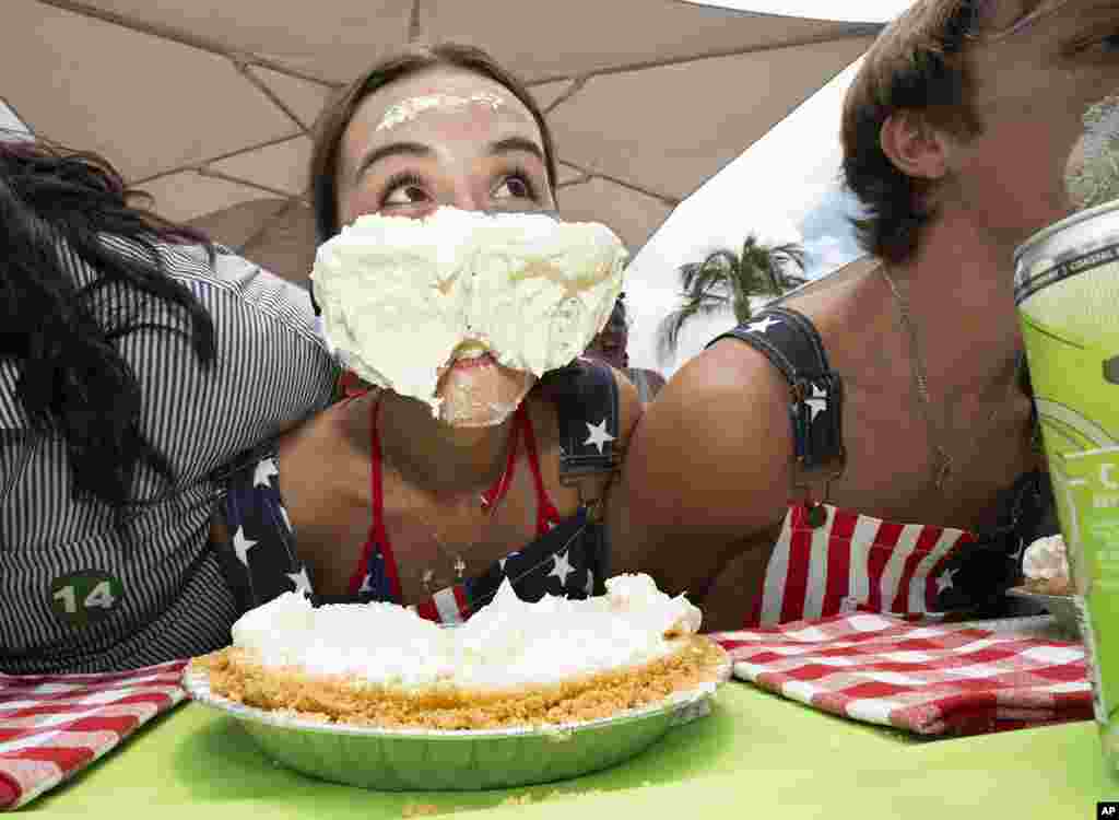 Maddie Miller, of Tampa, Florida, raises her head during the World Famous Key Lime Pie Eating Championship, In Key West, Florida, July 4, 2023. (Rob O'Neal/Florida Keys News Bureau via AP)