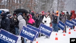 People wait to enter a Republican presidential candidate former President Donald Trump campaign event during a winter snowstorm in Atkinson, New Hampshire, Jan. 16, 2024.