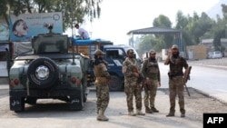 FILE - Taliban security personnel stand guard at the Pakistan-Afghanistan border in Torkham, Afghanistan, Sept. 15, 2023. Two Afghan insurgent groups claim to have killed at least 50 Taliban officials and soldiers during November. 