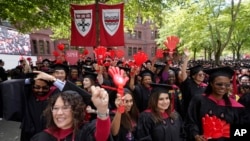 FILE - Graduating Harvard University students celebrate their graduate degrees in public health during Harvard commencement ceremonies, May 25, 2023, on the school's campus, in Cambridge, Mass.