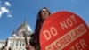 FILE - An Apache activist dancer performs in a rally to save Oak Flat, land near Superior, Arizona, sacred to Western Apache tribes, in front of the U.S. Capitol in Washington, July 22, 2015.