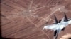 Na ovoj slici sa videa koji su objavile američke ratne snage, ruski SU-35 leti u blizini drona MQ-9 Reaper američkog ratnog zrakoplovstva 5. jula 2023. iznad Sirije.