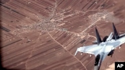 In this image from video released by the US Air Force, a Russian SU-35 flies near a US Air Force MQ-9 Reaper drone on July 5, 2023, over Syria.