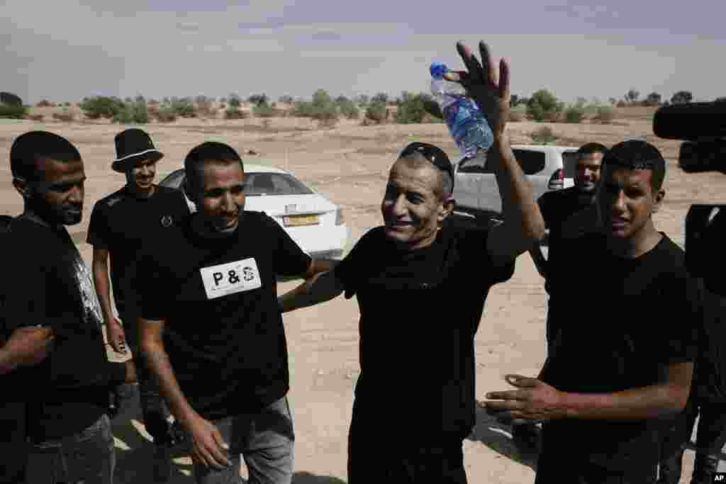 Qaid Farhan Alkadi, 52, who was held hostage by Hamas militants in Gaza Strip, meets his relatives and friends after arriving in the Khirbet Karkur village, near Rahat, southern Israel.