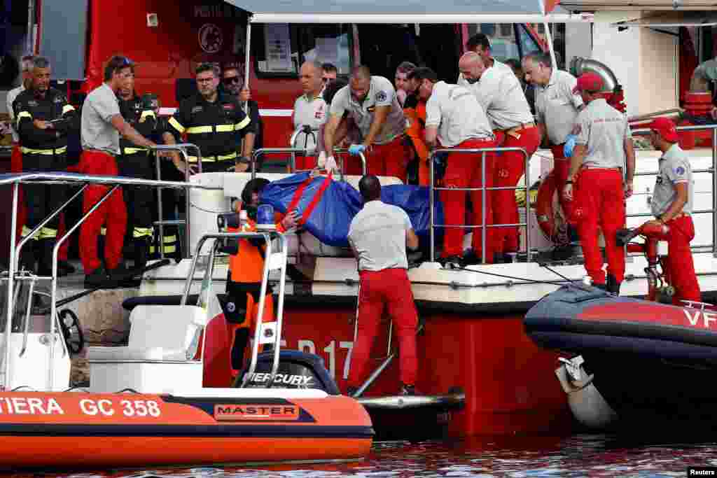 Rescue workers transport a body bag after a luxury yacht, which was carrying British entrepreneur Mike Lynch, sank off the coast of Porticello, near the Sicilian city of Palermo, Italy.