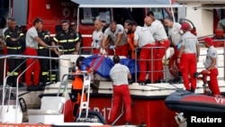 Rescue personnel transport a body bag after a luxury yacht, which was carrying British entrepreneur Mike Lynch, sank off the coast of Porticello, near the Sicilian city of Palermo, Italy, Aug. 21, 2024.