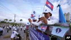 FILE - Cambodia's Candlelight Party supporters participate in marching during an election campaign for the June 5 communal elections in Phnom Penh, Cambodia, Saturday, May 21, 2022.