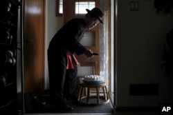 Nhia Neng Vang conducts a soul-calling ritual at his home in St. Paul, Minnesota, Nov. 18, 2023.