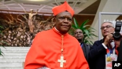 FILE - Cardinal Fridolin Among Besungu leaves after receiving the red three-cornered biretta hat from Pope Francis during a consistory inside St. Peter's Basilica, at the Vatican, Oct. 5, 2019.