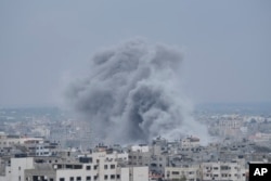 Smoke from an Israeli airstrike rises in Gaza City, Oct. 9, 2023.