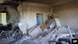 A man inspects his office obliterated by a drone during a night attack, in Kyiv, May 28, 2023.