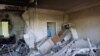Vladimir Golubenko looks at his office damaged by a drone during a night attack, in Kyiv, May 28, 2023. 