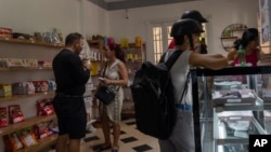 People shop at a private grocery store in Havana, Cuba, on Nov. 11, 2023. Dozens of tiny grocery stores have sprung up around Cuba in recent months, referred to locally as “mipymes” — pronounced MEE-PEE-MEHS — and offering many products not available elsewhere.
