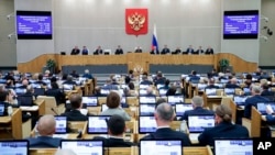 In this photo released by The State Duma, Russian lawmakers attend a session at the State Duma, the Lower House of the Russian Parliament in Moscow, Oct. 17, 2023. 