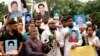 Hoping to spotlight cases of alleged victims of enforced disappearances, relatives and supporters hold photos of missing activists, in Dhaka, Bangladesh, Aug. 11, 2024. (Mosfiqur Johan for VOA)