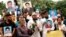 Hoping to spotlight cases of alleged victims of enforced disappearances, relatives and supporters hold photos of missing activists, in Dhaka, Bangladesh, Aug. 11, 2024. (Mosfiqur Johan for VOA)